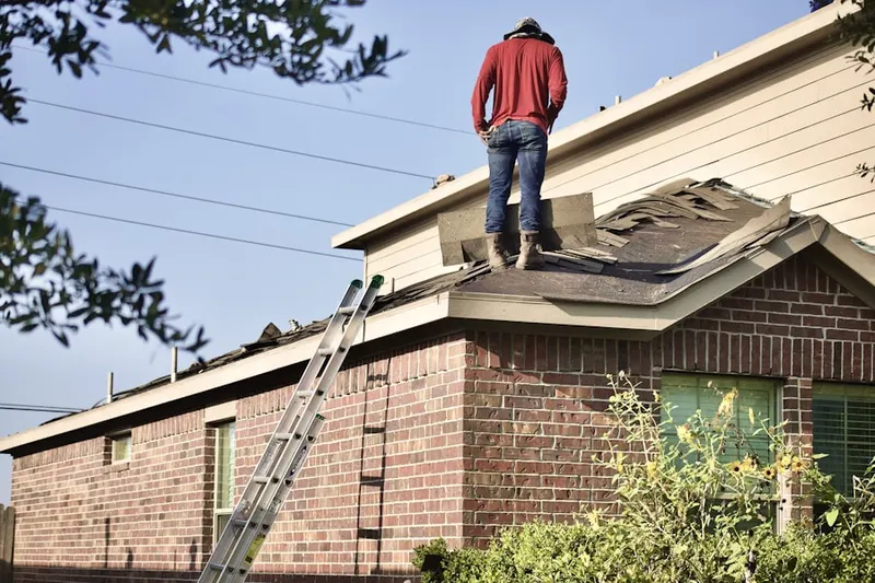 Professional roofer working on a residential roof in Northmont